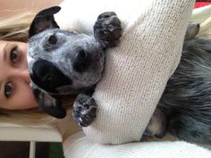 a woman holding a dog on her arm