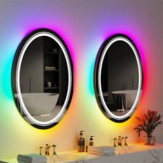 there are two sinks in the bathroom with mirrors on the wall above them, and one is illuminated by multicolored lights