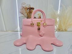 a pink purse sitting on top of a table