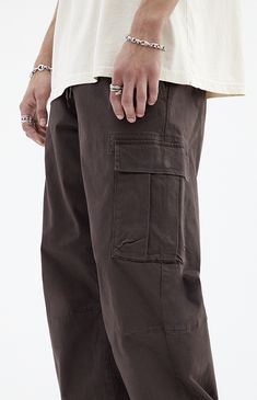 Stay effortlessly stylish with PacSun's Brody Brown Cotton Cargo Pants. With their relaxed fit, zip fly closure, and functional cargo pockets, these pants combine comfort and utility in a trendy brown finish, perfect for any casual outing.


	Model is wearing a size medium
	Model Measurements: 6'1” Height, 31” Waist, 32” Inseam


Learn more about PacSun eco items Black Mens Streetwear, Woodstock Outfit, Mens College Fashion, Brown Cargos, Thanksgiving Play, Cargo Pants Outfit Men, Mens Cargo Pants, Dark Brown Pants, Carhartt Cargo Pants