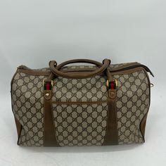 Gucci Sherryline Travel Bag Classic Gucci Monogram With Red And Green Stripped Details And Gold Hardware Approx 16x4x9.5” Has Two Top Handles And Long Shoulder / Crossbody Strap That Can Be Removed And Adjusted Date Code:40-02-073 One Interior Pocket One Exterior Pocket Functional Zippers Item Shows Signs Of Wear From Normal Use- Peeling On Interior, Wear On Leather Piping And Corners, Scratches And Scuffs Throughout, Tarnished&Scratched Hardware , Wear On Long Strap Etc Please Refer To Photos For Further Details Zarjp85308 Luxury Pre-owned Brown Bag, Pre-owned Rectangular Gucci Shoulder Bag, Pre-owned Designer Brown Bags, Pre-owned Gucci Shoulder Bag For Travel, Pre-owned Gucci Leather Bag, Elegant Monogram Canvas Travel Bag With Leather Trim, Gucci Brown Travel Bag, Pre-owned Classic Gucci Bags, Designer Brown Travel Bag With Top Handle