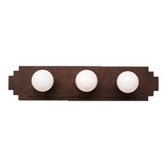 three white balls are mounted on an old - fashioned metal wall light, which is in the shape of a rectangle