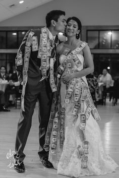 a man and woman standing next to each other in front of a dance floor with money on it