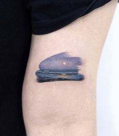 a watercolor painting style tattoo on the left thigh