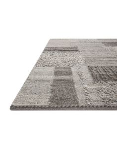 a gray rug with squares on the top and bottom in different colors, sizes and shapes