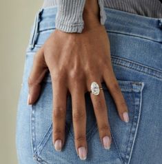 a close up of a person's hand with a ring on their finger