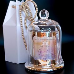 a clear glass jar with a gold lid next to a white bag