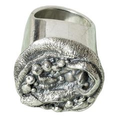 a silver ring with balls on the outside and inside, sitting in front of a white background