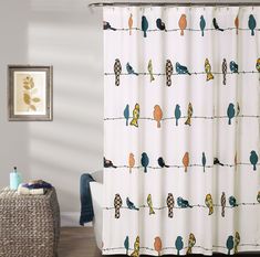 the shower curtain is decorated with birds on a wire and blue, green, yellow, orange