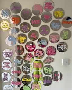 there are many circular mirrors on the wall with different colors and designs around them that say don't be lazy