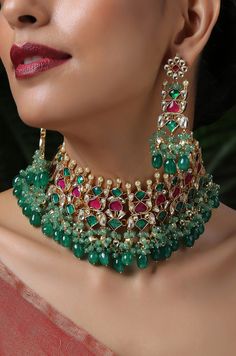 A beautifully handcrafted neckpiece worked in gold, finished with an array of semi-precious gemstone drops and encrusted with kundan. This choker set is based in silver alloy plated with 22k gold. Necklace Closure - Adjustable Dori Earrings Closure - Push Back Necklace - 14 inches Earrings - 3.5 inches Style Tip - A perfect choker for someone who's styling decisions always start and end with putting timeless classics together to create a magical and unique look. An accessory so versatile, we are Festive Necklaces With Stones, Festive Stone Necklaces, Ceremonial Kundan Jeweled Necklace, Fusion Style Festive Necklaces With Stones, Festive Multicolor Stone Necklaces, Fusion Style Festive Kundan Necklace With Jewels, Festive Fusion Style Kundan Necklace With Jewels, Festive Fusion Necklace With Jewels, Festive Kundan Necklaces With Stones