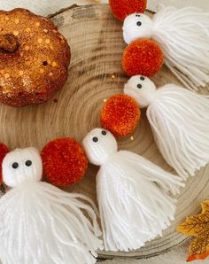 some tassels are on a wooden plate with a donut in the background