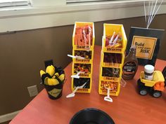 the table is set up with two bins filled with candy and candies for halloween