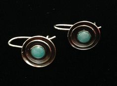 Soft, blue turquoise gemstones stones are set in two discs of sterling and oxidized to set off the dimension and color of the stones. Handmade, hook closure keep them securely attached to your ear as they softly sway and catch the light. Mixed metals version here: https://www.etsy.com/listing/191226469/turquoise-and-silver-earrings-golden Turquoise not your preferred stone? Inquire within - I can replace the gem with one of the hundreds of options I have on-hand! Hang just under an inch from you Modern Turquoise Round Earrings, Silver Jewelry Handmade, Mixed Metals, Turquoise Blue, Turquoise Gemstone, Turquoise Earrings, Stone Earrings, Sterling Earrings, Earrings Handmade