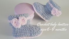 a pair of crocheted slippers with pink flowers on the top and bottom