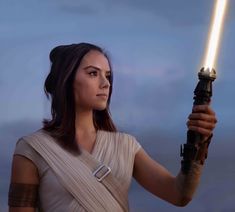 a woman holding a light saber in her hand