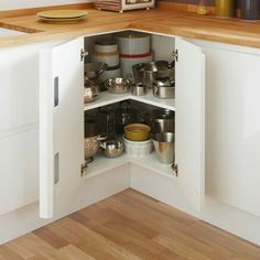 an open corner in a kitchen with pots and pans