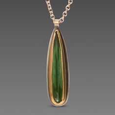 An slim teardrop of deep green, rose cut tourmaline is wrapped in warm 22k gold. Backed with sterling silver and suspended from a delicate 14k gold chain. Simple and so elegant. Pendant measures approximately 3/8 inch in length. Matte finish. Everyday Green Teardrop Pendant Jewelry, Green Teardrop Pendant Necklace With Gemstone, Luxury Green Teardrop Pendant Jewelry, Green Tourmaline Teardrop Jewelry, Green Teardrop Faceted Necklace, Elegant Pendant, Green Rose, Teardrop Necklace, Green Necklace