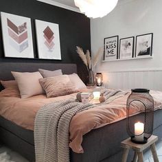 a bed room with a neatly made bed and two pictures on the wall above it