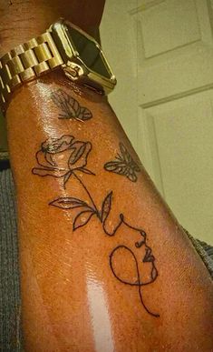 a woman's arm with a tattoo on it that says love and flowers in black ink