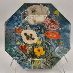 a glass plate with flowers painted on it