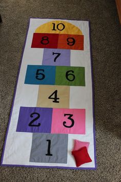 a child's play mat with numbers on it and the words hopscoh mat