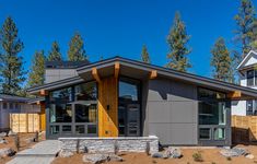 a modern home in the woods with large windows