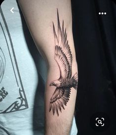 a man's arm with an eagle tattoo on it