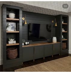 a living room with shelves and a tv on top of the entertainment center that is built into the wall