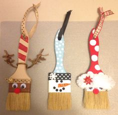 three painted brush ornaments hanging on the wall with reindeer noses, nose and mouth decorations