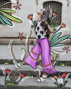 a woman is walking down the street in front of a painted mural on concrete steps