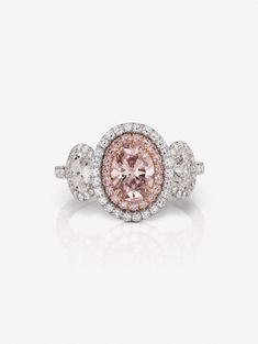 Brown Pink Diamond Oval Three Stone Ring by J FINE with a 1.00ct Oval Fancy Brown-Pink SI2 with GIA, set with 2x0.81ct white oval diamonds, 0.22ct pink diamonds and 0.66ct white diamonds. 18K White and Pink Gold. As each Brown Pink Diamond Oval Three Stone Ring is handmade with handset diamonds consistent with all pieces in the J FINE jewelry line, carat weight and stone quantity may vary slightly from piece to piece. If this product is sold out and you wish to order, contact us. To replenish ou Oval Pink Gia Certified Diamond Ring, Gia Certified Oval Pink Diamond Ring, Luxury Pink Oval Diamond Ring, Luxury Pink Oval Halo Ring, Pink Oval Diamond Ring With Brilliant Cut, Pink Oval Halo Ring For Formal Occasions, Formal Oval Pink Halo Ring, Formal Pink Oval Halo Ring, Pink Oval Diamond Ring With Halo Design