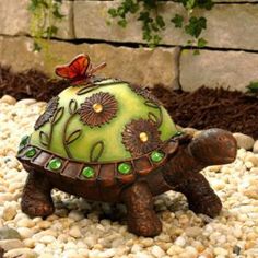 a small turtle statue sitting on top of some rocks