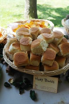 a table topped with lots of sandwiches and buns