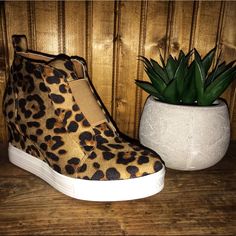 Leopard Print Wedge Sneakers Hot Item Price Firm Best Seller Leopard Wedge Sneaker Booties So So Comfy And Cute! We Are Loving These Little Booties! Dress Them Up With A Cute Dress Or Causally With A Pair Of Jeans And A Cute Top! Per Our Customers They Have Bought Their Normal Size. 2.75" Heel Padded Insole Faux Suede Rubber Sole Elastic Front Top Inner Zip Close Perforated Body True To Size, Size Up If You're In Between Sizes Casual Brown Platform Wedge Boots, Casual Brown High-top Wedge Boots, Brown Casual Wedge Sneakers For Spring, Casual Brown Platform Wedge Sneakers, Brown High-top Platform Wedge Sneakers, Jeans And A Cute Top, Booties Dress, Leopard Print Wedges, Leopard Wedges