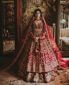 a woman in a red and gold bridal gown