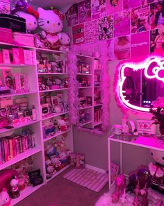 a room filled with lots of toys and pink lights on the walls, including hello kitty decorations