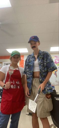 two people dressed in costumes standing next to each other with utensils on their heads