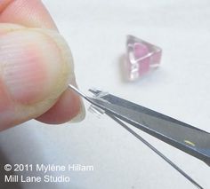 a person is cutting glass with a pair of scissors