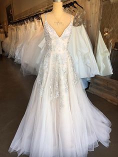 a white wedding dress on display in a store