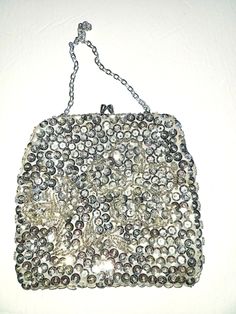 Absolutely gorgeous 60s Du-Val designer silver evening clutch purse with a kiss lock. The purse was made in Hong Kong and is highly decorated with beads and sequin with a beautiful flower beaded in the middle of the bag. The chain and the kiss lock are silver tone, the lining of the bag is silk satin. The bag has never been used before and is in mint condition. The bag will definitely match your evening dress and will also make a beautiful gift! For more items in my store visit: https://www.etsy Vintage Rectangular Evening Bag For Party, Vintage Pouch Bag For Party, Vintage Embellished Clutch For Party, Vintage Handmade Evening Bag For Party, Vintage Silver Handmade Bag, Retro Silver Rectangular Bags, Retro Silver Rectangular Bag, Vintage Handmade Silver Bag, Vintage Silver Rectangular Clutch