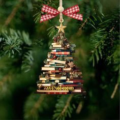 a christmas tree made out of books hanging from a branch