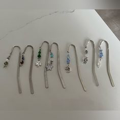 seven pairs of hair pins are lined up on a table