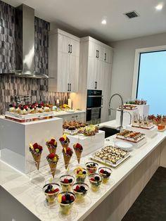 a kitchen filled with lots of food on top of a counter