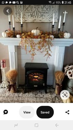 the fireplace is decorated with fall decorations and candles