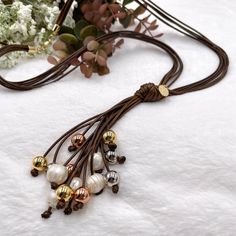 Brown cord necklace, lariat necklace beaded, pearl lariat necklace, long boho statement necklace, cord necklace with pearls, big sister gift. This multi cord necklace carries a soft feminine energy and stylish boho looks. Comfort in his entire expression! You will look amazing wearing this boho chic necklace, because of its unique style.  💕 ITEM DETAILS: Total Length: 26.5 inches. The length of the necklace refers to the total length from end-to-end. Pendant height and width: Approximately 5 in Pearl Lariat Necklace, Pearl Lariat, Boho Statement Necklace, Boho Chic Necklace, Big Sister Gifts, Necklace Big, Mask Necklace, Necklace Pearl, Pearl Hoop Earrings