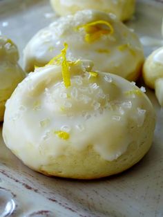 lemon cookies with icing and sprinkles on a plate