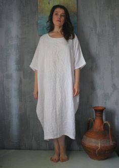 "Linen loose dress. How nice to feel the touch of soft and cooling linen fabric, especially in the summer heat. This dress is not only comfortable, but also very stylish. It is made from specially processed softened flax natural color. Very original with elegant pockets in the style of Boho. In the side seams of the pocket. Perfectly sits on large sizes. Made of specially treated linen. Available in other colors . This is oversize dress. We will sew the big sizes according to your order! Availab White Bohemian Linen Dress Made Of Ramie, Flowy Linen Casual Midi Dress, Oversized Bohemian Linen Dress For Spring, White Linen Dress For The Beach, White Ramie Linen Beach Dress, White Bohemian Ramie Linen Dress, Flowy Linen Midi Dress Casual Style, White Ramie Linen Dress For Beach, Oversized Linen Summer Dress