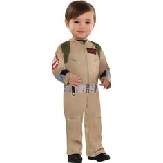 a little boy in a costume that is wearing a pilot's suit and smiling at the camera