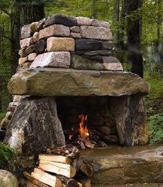 an outdoor fireplace made out of rocks and logs